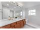 Bright white bathroom featuring double sinks, vanity, and a large mirror at 14145 Charity Chase Cir, Carmel, IN 46074