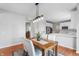 Inviting dining room features wood table, seating for four, and an overhead chandelier at 14145 Charity Chase Cir, Carmel, IN 46074