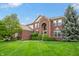 Beautiful brick home featuring a lush green lawn and mature landscaping adding to its appeal at 14145 Charity Chase Cir, Carmel, IN 46074
