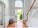 Bright foyer with hardwood floors, staircase, and large window over entryway allowing natural light at 14145 Charity Chase Cir, Carmel, IN 46074