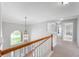 Upstairs hallway featuring a decorative light fixture and a large window at 14145 Charity Chase Cir, Carmel, IN 46074