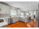 Modern kitchen featuring white cabinets, quartz countertops, and stainless steel appliances at 14145 Charity Chase Cir, Carmel, IN 46074