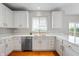Bright kitchen features white cabinets, stainless steel appliances and gleaming countertops at 14145 Charity Chase Cir, Carmel, IN 46074
