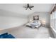 Spacious carpeted main bedroom featuring a ceiling fan, natural light, and comfortable bed at 14145 Charity Chase Cir, Carmel, IN 46074