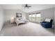 Bright main bedroom featuring a ceiling fan, natural light, and an accent chair at 14145 Charity Chase Cir, Carmel, IN 46074