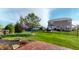 Landscaped backyard features a well-manicured lawn, mature trees, and a patio area for outdoor living at 1435 Colony Park Dr, Greenwood, IN 46143