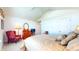 A cozy bedroom features a comfortable bed and an armchair next to a dresser, all beneath a vaulted ceiling at 1435 Colony Park Dr, Greenwood, IN 46143