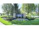 Crooked Bend community entrance with stone pillars, colorful flower bed, and lush green landscaping near a pond at 1435 Colony Park Dr, Greenwood, IN 46143