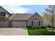 Charming exterior featuring a brick facade, an attached two-car garage, and a well-kept lawn at 1435 Colony Park Dr, Greenwood, IN 46143