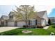Charming two-story brick home with a well-manicured lawn and a three car attached garage at 1435 Colony Park Dr, Greenwood, IN 46143