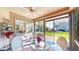 Cozy sunroom with ceiling fan, sliding glass windows, and view of the landscaped backyard at 1435 Colony Park Dr, Greenwood, IN 46143