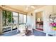 Enclosed sunroom featuring a glass table, neutral decor, and access to the house at 1435 Colony Park Dr, Greenwood, IN 46143