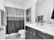 Stylish bathroom featuring a modern vanity, framed mirror, and a shower with elegant grey accents and modern fixtures at 1702 Alvord St, Indianapolis, IN 46202