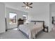 Bright bedroom with neutral decor, a ceiling fan, carpeted floor, and two windows that let in plenty of natural light at 1702 Alvord St, Indianapolis, IN 46202