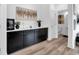 Dining room with elegant black cabinetry, a stylish wine cooler, and tasteful decor, perfect for hosting dinners at 1702 Alvord St, Indianapolis, IN 46202