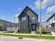 Modern two-story home featuring sleek dark siding and well-manicured landscaping at 1702 Alvord St, Indianapolis, IN 46202