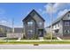 Modern two-story home featuring sleek dark siding and manicured landscaping at 1702 Alvord St, Indianapolis, IN 46202
