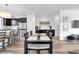Modern kitchen and dining space with stainless steel appliances, center island and hardwood floors offering a blend of style and function at 1702 Alvord St, Indianapolis, IN 46202