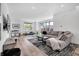 Spacious living area with hardwood floors, large windows, and a comfortable sofa, providing a bright and inviting space at 1702 Alvord St, Indianapolis, IN 46202