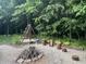 Landscaped backyard featuring a fire pit, trees, and landscaping at 17027 Rainier Cir, Westfield, IN 46062