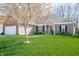 Inviting home with lush green lawn, brick facade, and a vibrant tree adding charm to the exterior landscape at 17027 Rainier Cir, Westfield, IN 46062