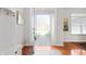 Bright foyer with hardwood floors, coat rack, and artwork, leading to a view of the front yard at 17027 Rainier Cir, Westfield, IN 46062