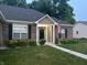 Charming brick home with dark shutters, flowers, well-manicured lawn, and inviting entrance at 17027 Rainier Cir, Westfield, IN 46062