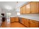 Well-lit kitchen featuring wooden cabinets, quartz countertops, a stainless steel sink, and a view of the backyard at 17027 Rainier Cir, Westfield, IN 46062