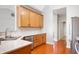 Well-lit kitchen featuring wood cabinetry, stainless steel appliances, and granite countertops at 17027 Rainier Cir, Westfield, IN 46062