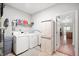 Functional laundry room featuring a washer, dryer, storage cabinet, and neutral colors at 17027 Rainier Cir, Westfield, IN 46062