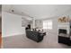 Spacious living room featuring a cozy fireplace, a large sectional sofa, and neutral carpet for comfortable living at 17027 Rainier Cir, Westfield, IN 46062