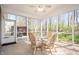 Sunroom with a glass table, chairs, and screened windows offering views of the backyard at 17027 Rainier Cir, Westfield, IN 46062