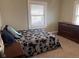 Bedroom with patterned bedding, a dresser, and natural light from the window at 1802 Poplar St, Anderson, IN 46012