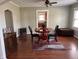 Elegant dining room featuring hardwood floors, a rustic table, and stylish decor at 1802 Poplar St, Anderson, IN 46012