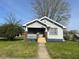 Charming single-story home featuring a quaint front porch and well-maintained lawn at 1802 Poplar St, Anderson, IN 46012