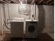 Functional basement laundry area with washer and dryer for convenient chores at 1802 Poplar St, Anderson, IN 46012