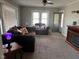 Cozy living room with plush furniture, carpet flooring, and a decorative fireplace at 1802 Poplar St, Anderson, IN 46012
