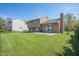 Well-maintained backyard featuring a lush green lawn, a patio, and a chain-link fence at 18771 Northridge Dr, Noblesville, IN 46060