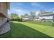 Backyard featuring a large grassy area, a patio, and a chain-link fence at 18771 Northridge Dr, Noblesville, IN 46060