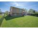 Expansive backyard with a green lawn, chain-link fencing, and plenty of space for outdoor activities at 18771 Northridge Dr, Noblesville, IN 46060