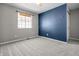 A bedroom with soft carpet, neutral-toned walls, a contrasting accent wall, and a window for natural light at 18771 Northridge Dr, Noblesville, IN 46060