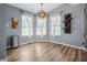 Bright dining area featuring a modern chandelier, ample natural light, and a convenient wine rack at 18771 Northridge Dr, Noblesville, IN 46060