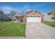 Charming single-Gathering home featuring a manicured lawn, brick accents, and a two-car garage at 18771 Northridge Dr, Noblesville, IN 46060