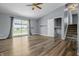Bright living room featuring sliding glass doors, modern flooring, and staircase access at 18771 Northridge Dr, Noblesville, IN 46060