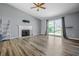 Cozy living room featuring modern flooring, a fireplace, sliding glass doors, and contemporary decor at 18771 Northridge Dr, Noblesville, IN 46060