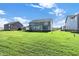 Expansive backyard featuring a green lawn and back view of the attractive home at 19472 Lewis Cir, Westfield, IN 46074