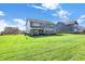 Spacious backyard with lush green lawn and view of the rear of the home at 19472 Lewis Cir, Westfield, IN 46074