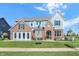 Stunning new construction home featuring brick accents, a manicured lawn and a charming covered entry way at 19472 Lewis Cir, Westfield, IN 46074