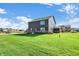 Spacious backyard with lush green grass, perfect for outdoor activities and entertaining, with a home view at 19492 Lewis Cir, Westfield, IN 46074