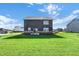 Large, well-maintained backyard offers ample space for recreation, with a view of the home's exterior at 19492 Lewis Cir, Westfield, IN 46074